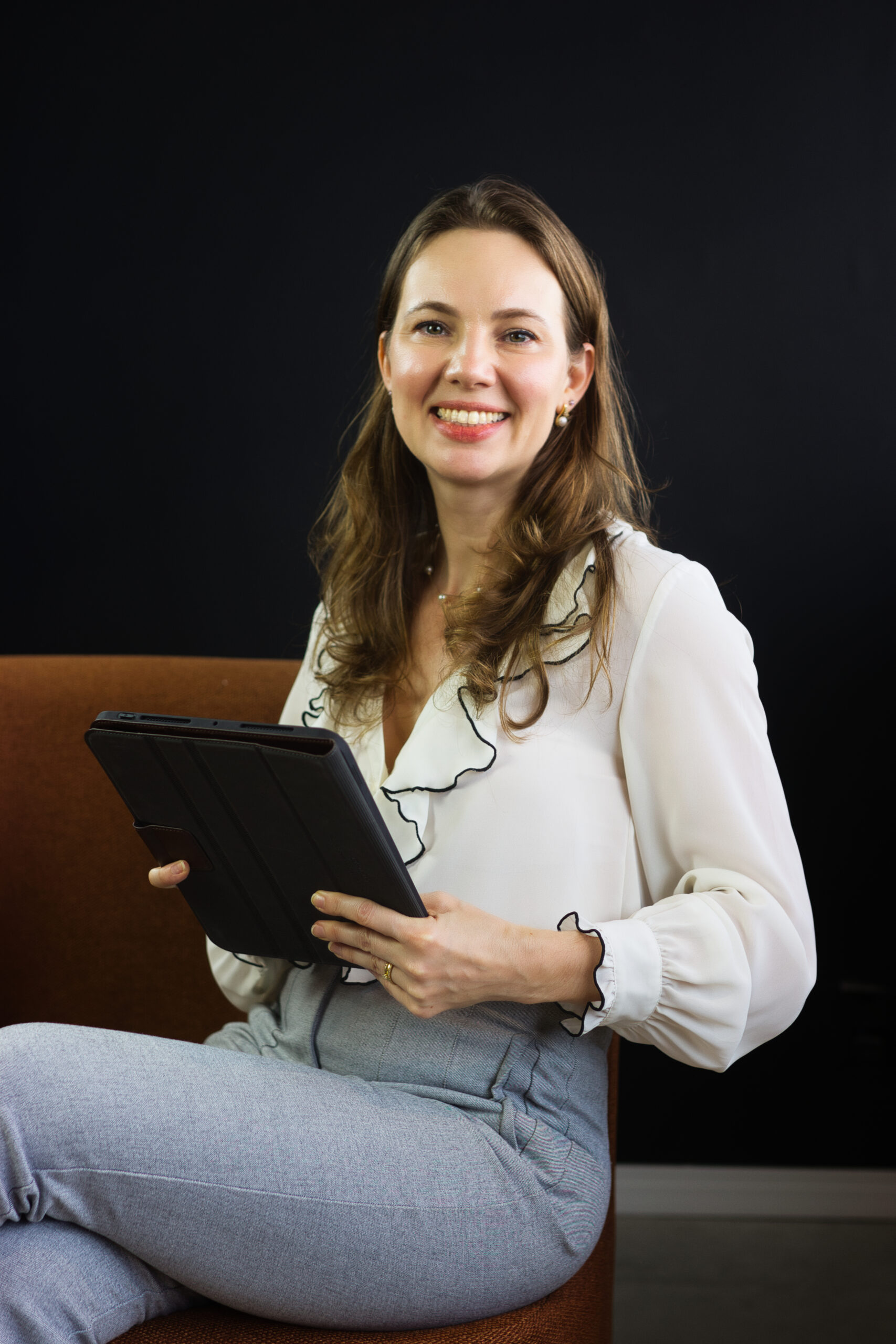 Caroline Schmidt, Associate Attorney, standing in a corporate setting.