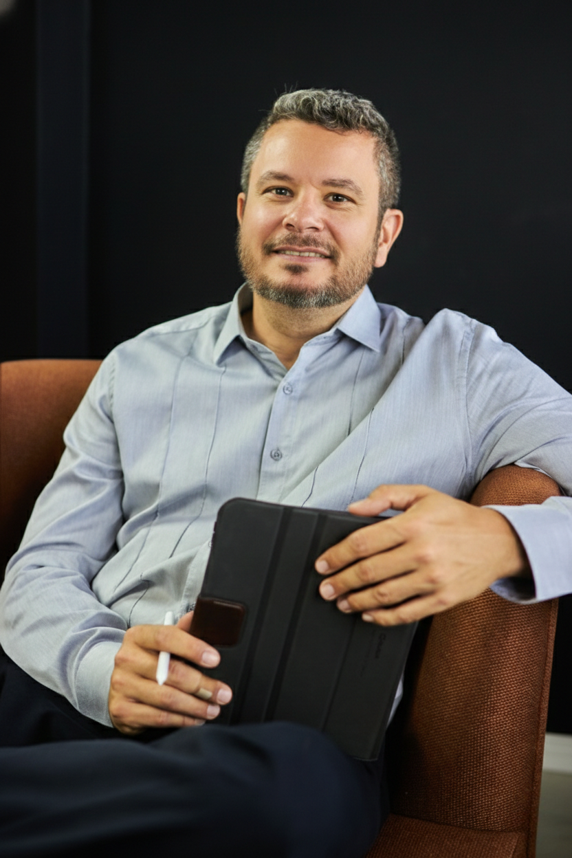 Jose Lima, Business Development Manager, sitting and holding a tablet.
