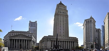 Panoramic view of the Thurgood Marshall U.S. Courthouse and historic government buildings at Foley Square in New York City under a clear blue sky